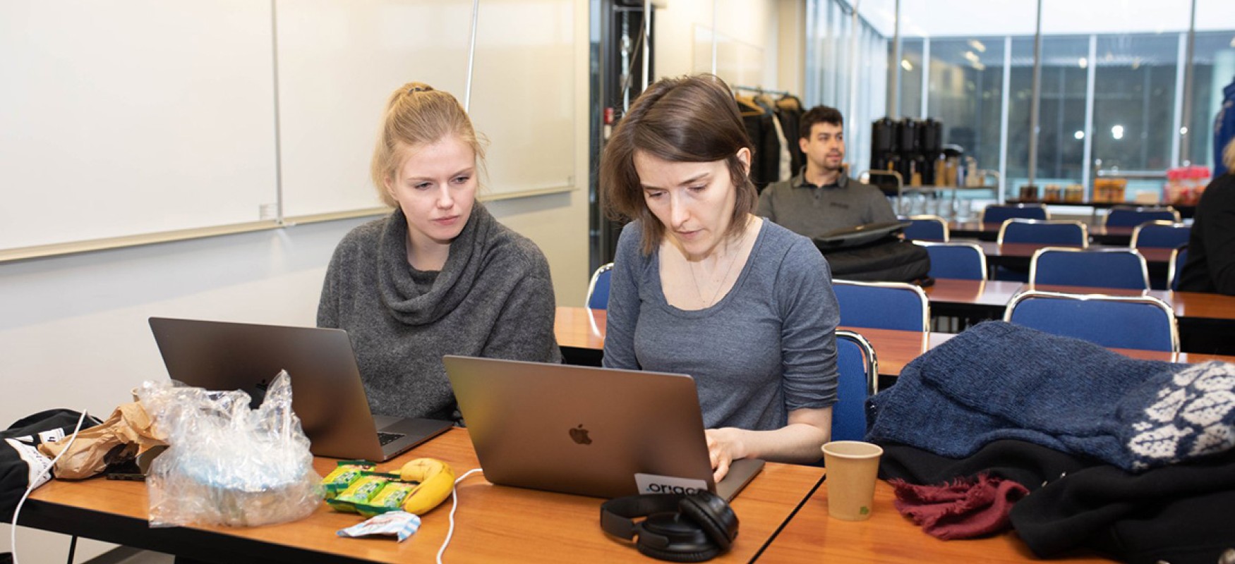 Two people in front of a laptop at a hackathon in Reykjavik.