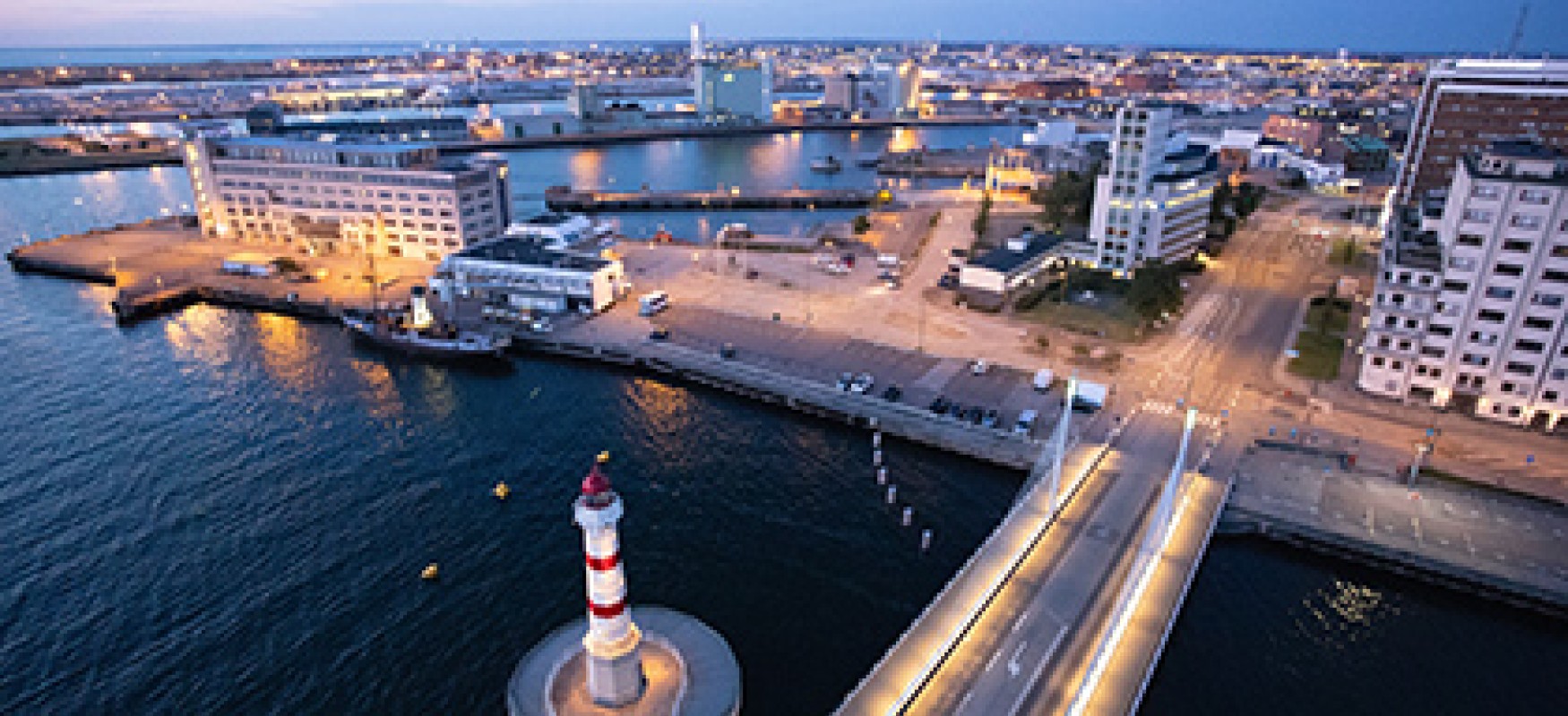A light house and port pictured from above.
