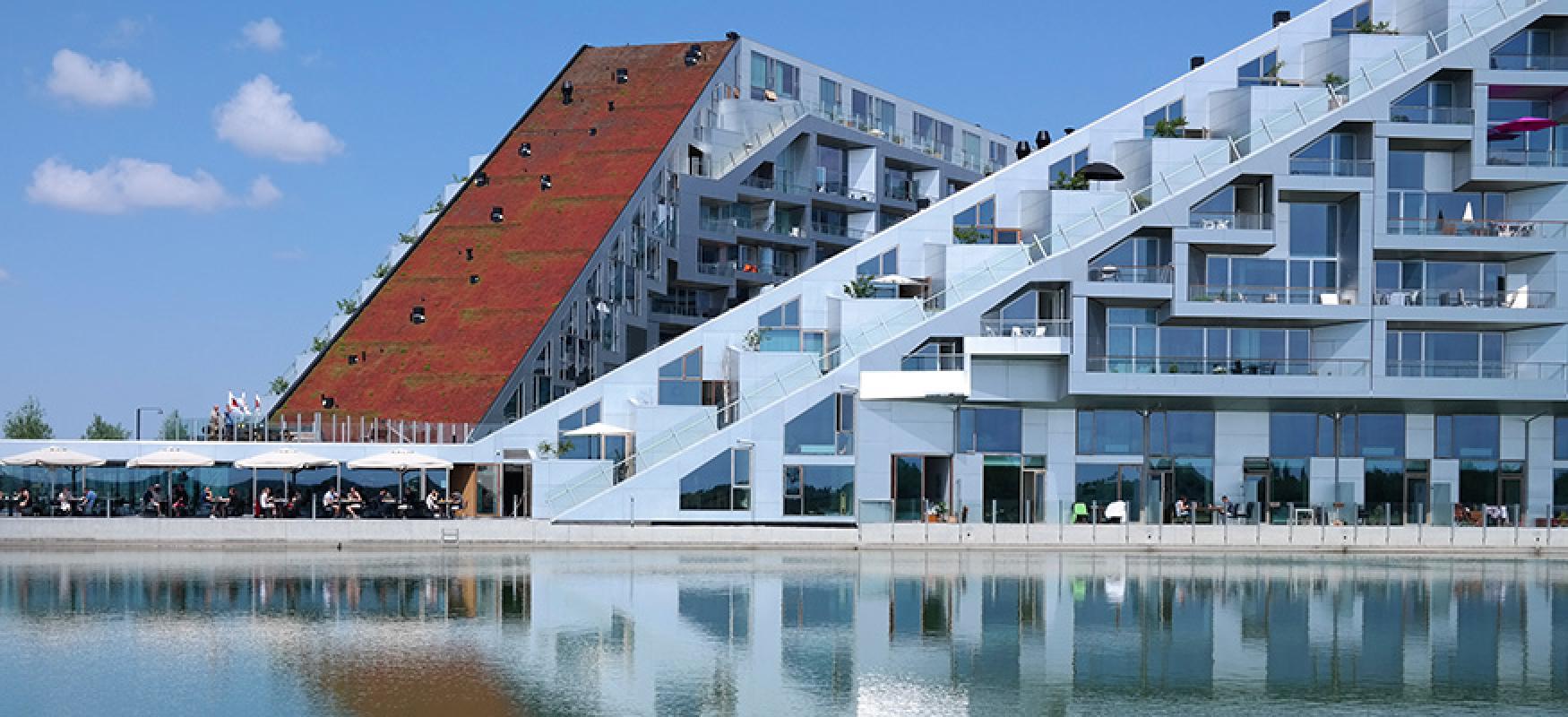 White building next to a dock and water