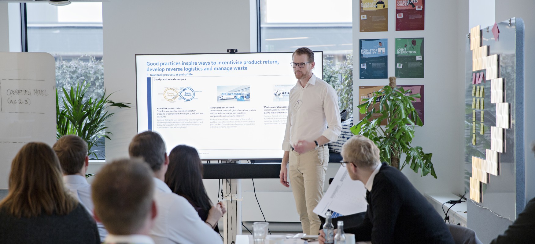 Workshop participants in circular economy workshop listening to a presentation.