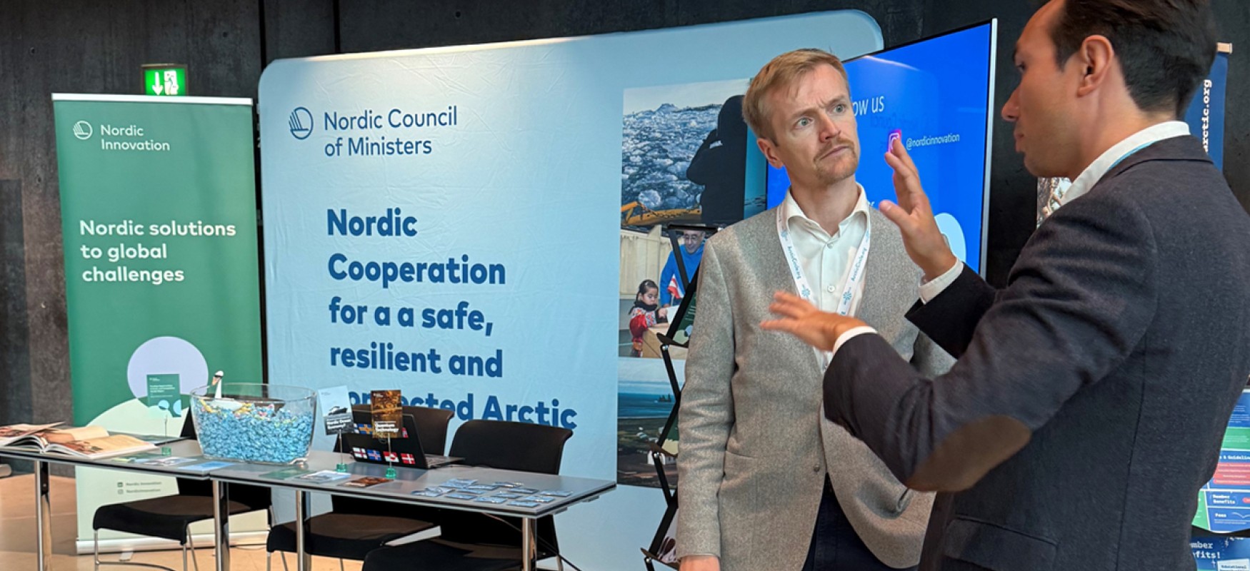 Emil talking to a person attending our stand at Arctic Circle Assembly