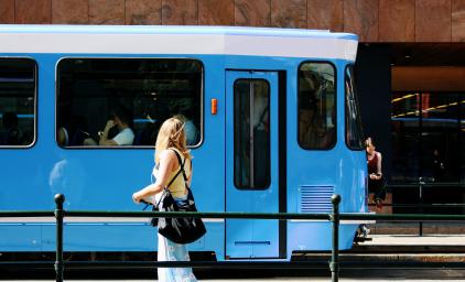 Tram in Oslo driving by on a sunny day.