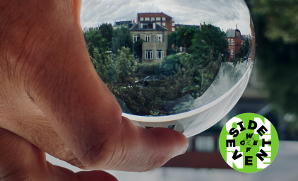 Person holding glass globe with reflecting building and trees in the background. WCEFonline sideevent logo