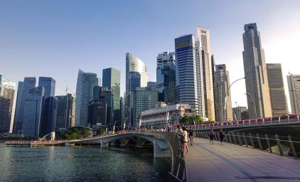 A waterside boardwalk with the Singapore skyline in the background.