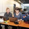 Two people in front of a laptop at a hackathon in Reykjavik.