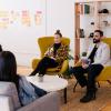 Five people having a business meeting in a modern office.